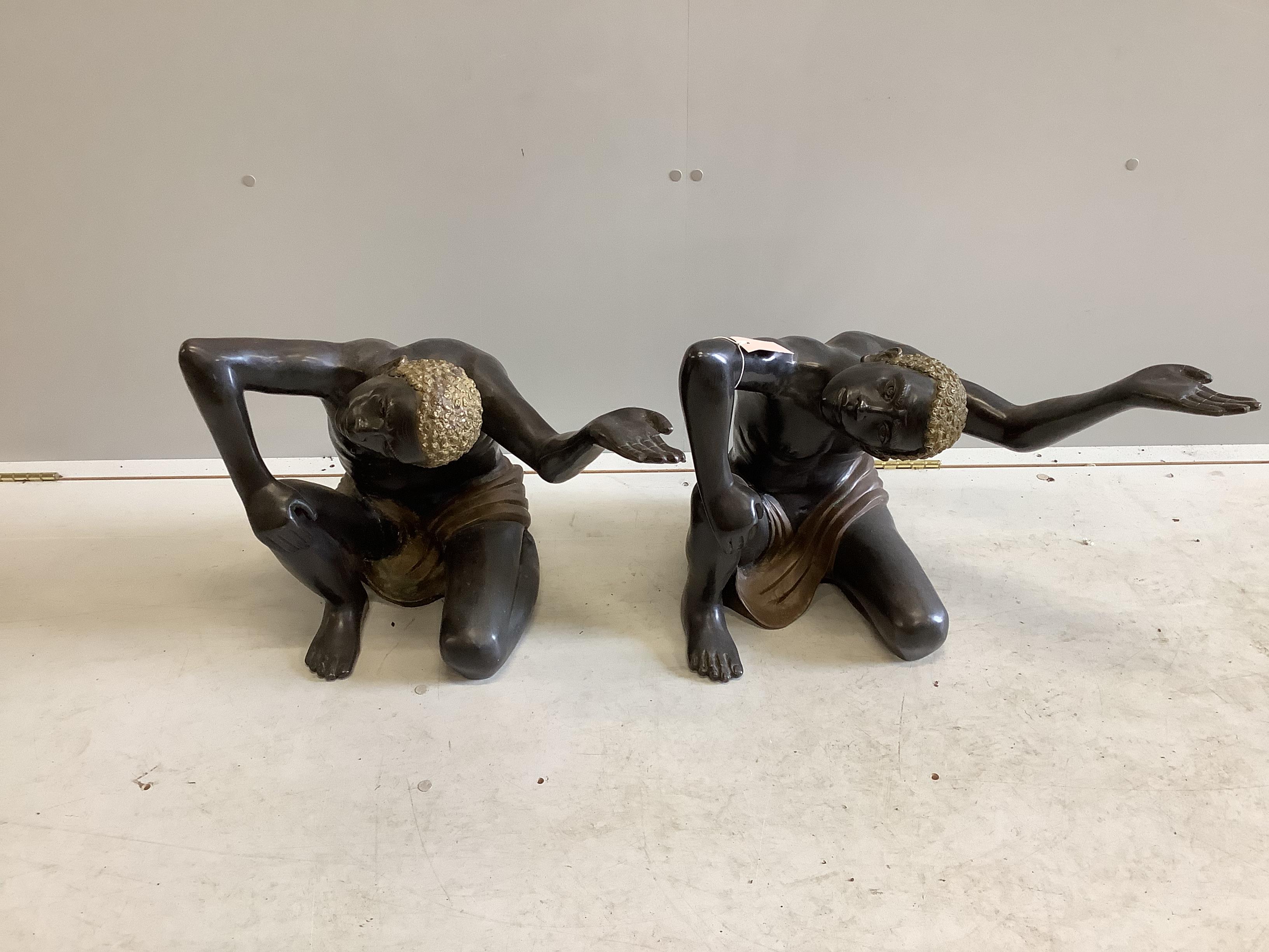 A pair of bronze Blackamoor table stands, width 57cm, height 43cm